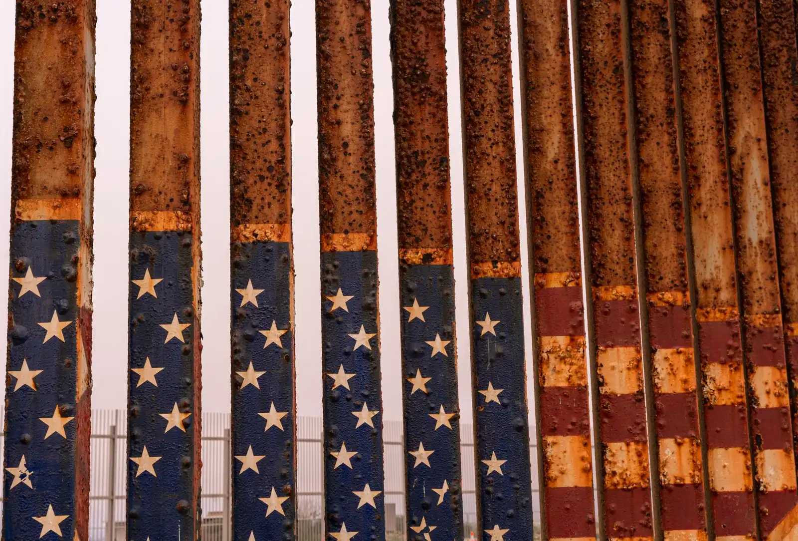 Rusty border fence painted with the American flag at the U.S.-Mexico border near Tijuana